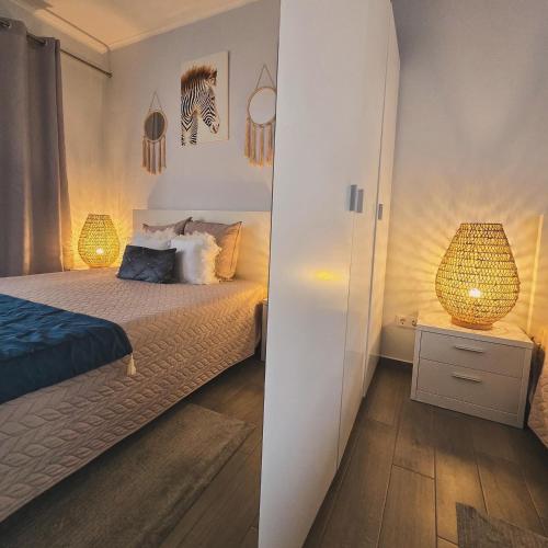 a bedroom with a bed with two lamps on it at Welcome Pico in Madalena