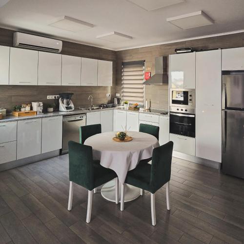 a kitchen with a table and chairs in a kitchen at Welcome Pico in Madalena