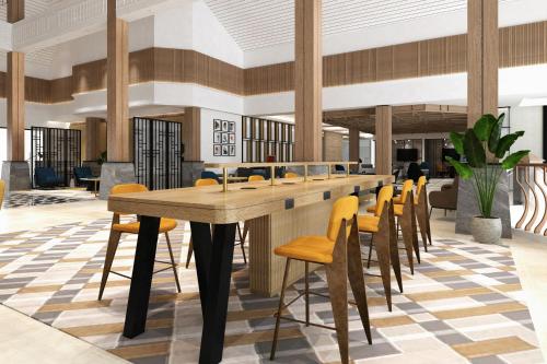 a dining room with a long table and chairs at Sheraton Jakarta Soekarno Hatta Airport in Tangerang
