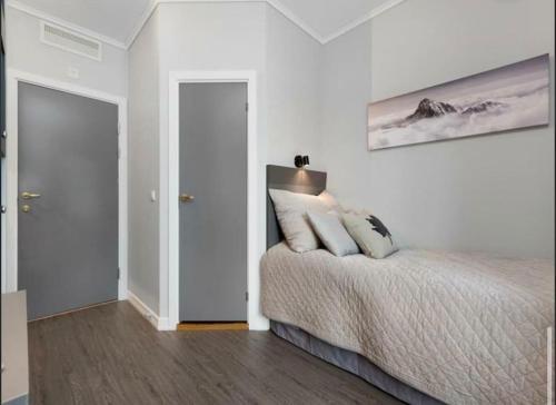 a bedroom with a bed and a picture on the wall at Studio Apartment Oslo AirPort in Gardermoen