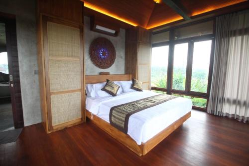 Кровать или кровати в номере Villa Taru Jagat