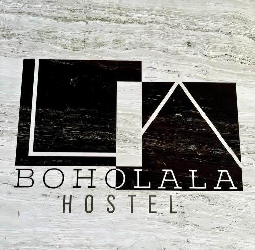 a sign for aothala hospital on a wooden wall at Boholala hostel in Panglao
