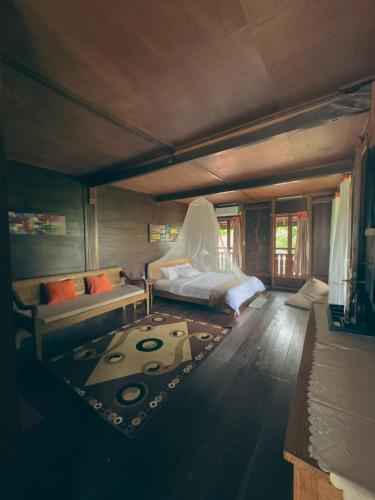 a bedroom with a bed with a veil on it at Munduk Tjeraki House in Munduk