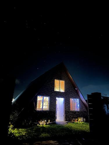 a home lit up at night with a white door at Casa María in Siguatepeque