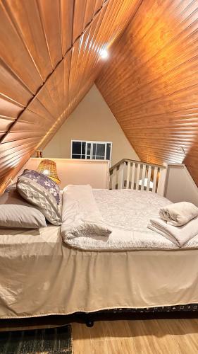 a large bed in a room with a wooden ceiling at Casa María in Siguatepeque