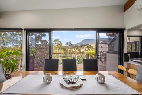 a kitchen and dining room with a table with a view at Tree Top Views - Magnificent 4 Bedroom House - 3 Minutes to MONA in Rosetta