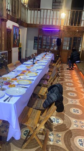 a long long table in a large room at Four Season Hostel in Bogotá