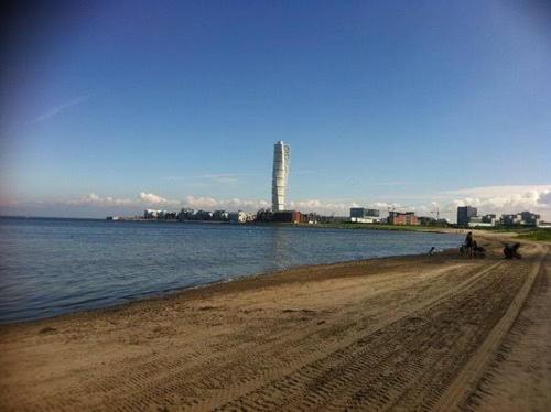 a sandy beach next to a body of water at Mysig lägenhet eurovision 2024 in Malmö