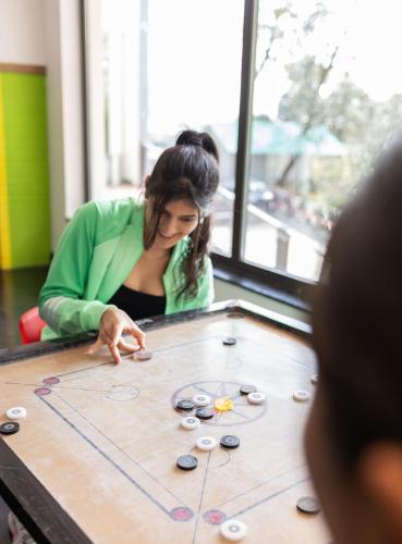 a woman playing a game on a table at The Oasis Mussoorie - A Member of Radisson Individuals in Mussoorie