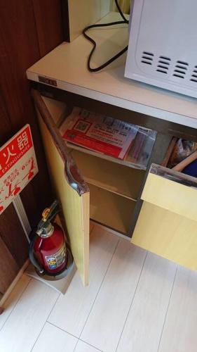 a desk with a book shelf and a fire hydrant at River Side izumi in Chōjamachi