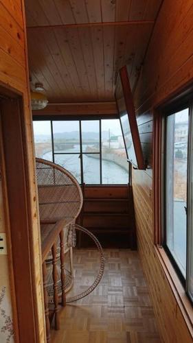 an inside view of a room with a table and windows at River Side izumi in Chōjamachi