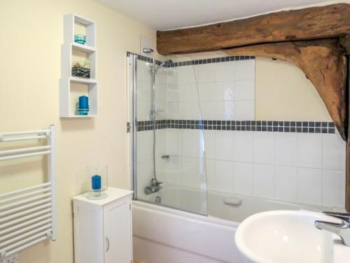 a bathroom with a shower and a sink and a tub at 3 Hazlewood in Aldringham