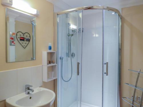 a bathroom with a shower and a sink at 3 Hazlewood in Aldringham