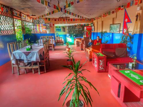 a restaurant with a table and chairs in a room at Best Hostel in Kathmandu