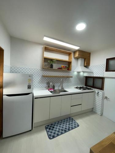 a kitchen with a white refrigerator and a sink at 한옥스테이 오늘 Hanok Stay Ohneul in Gyeongju