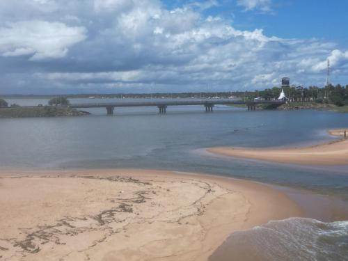 a bridge over a body of water with a beach at Villa Wonne 1 Floor Family Appartement! in Arugam Bay