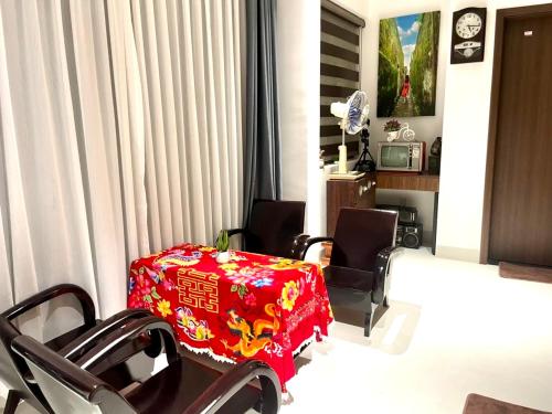 a living room with a red table and chairs at The Dragon Villa Hoi An in Hoi An