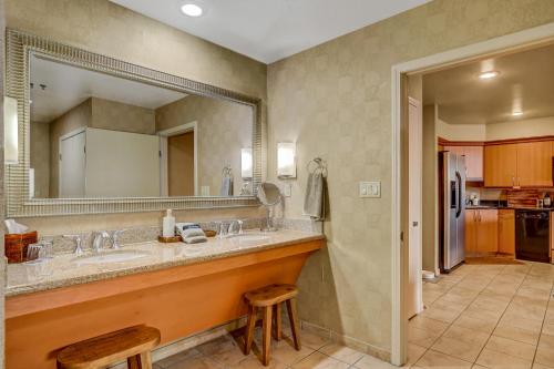 a bathroom with two sinks and a large mirror at Diligence at The Platinum - NO Resort Fees and Free Parking in Las Vegas