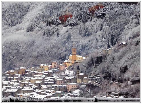 a small town covered in snow on a mountain at Hotel Rezia in Sondalo