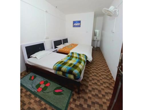 - une chambre avec un lit et une paire de chaussons dans l'établissement White House Resort, Sansari kund, Guptkashi, à Ukhimath