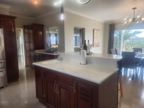 a kitchen with a sink and a counter top at Beautiful Battersea Lodge in Mandeville