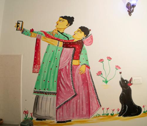a mural of a man and a woman in saris at Soham Haveli Udaipur in Udaipur