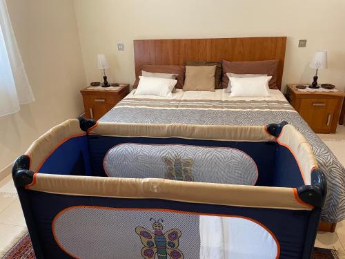 a large bed in a room with a bed frame at Seaview Family Apartment, Pool, Easy Access to the Sea, Near Mellieħa Bay in Mellieħa