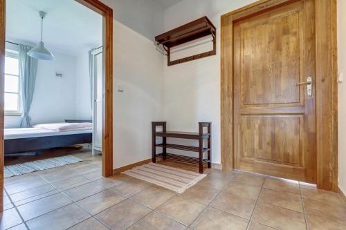 a room with a wooden door and a bedroom at Chalupa pod skalami in Božanov