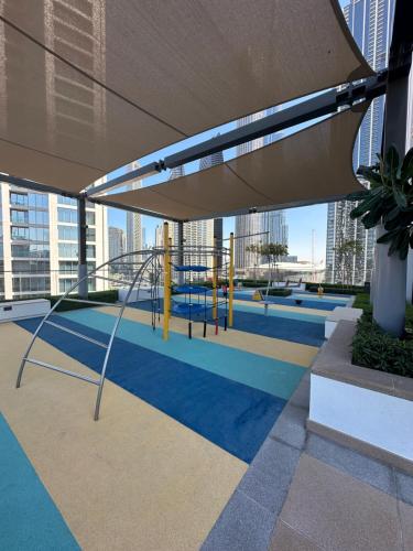 a playground in a building with a large umbrella at Burj Crown 2BR Apartment with Panoramic Burj Khalifa View in Dubai