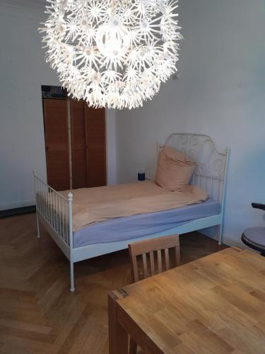 a bedroom with a bed and a chandelier at Apartment Villa Nähe Bahnhof in Heide