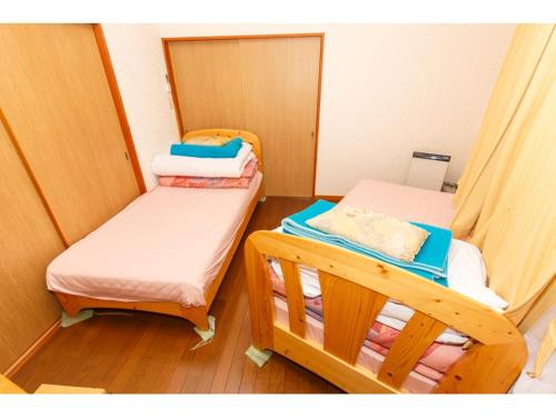 a small room with two bunk beds in it at Lake Kawaguchi Rental Villa Tozawa Center - Vacation STAY 46833v in Oishi