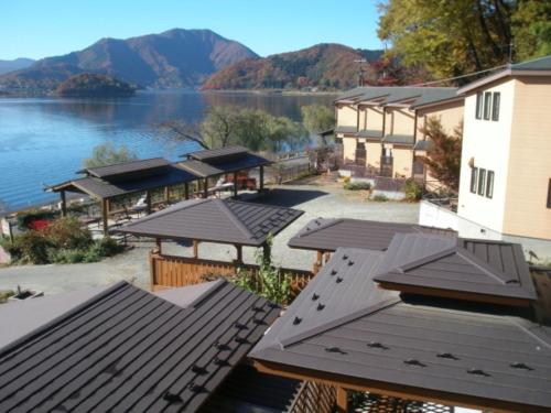 arial view of a resort with a lake and mountains at Lake Kawaguchi Rental Villa Tozawa Center - Vacation STAY 46833v in Oishi