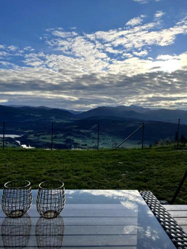 three baskets sitting on top of a table with a view at Apartment with beautiful panoramic view in Skulestadmo