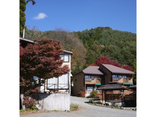 a row of houses with trees in the background at Lake Kawaguchi Rental Villa Tozawa Center - Vacation STAY 46850v in Oishi