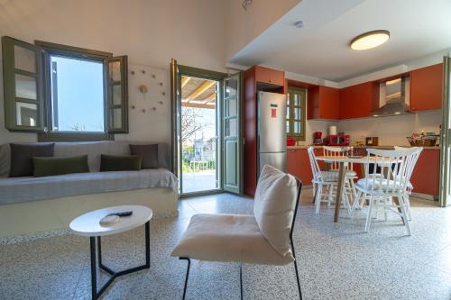 a living room with a couch and a table at Villa Rosa - Luxury Villas with Panoramic Views in Lagoúdi Zía