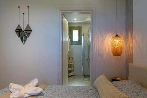 a bedroom with a bed with a white bow on it at Villa Rosa - Luxury Villas with Panoramic Views in Lagoúdi Zía