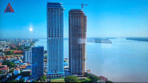 a view of two tall buildings next to the water at Morgan enmaison in Phnom Penh