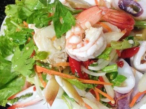 a salad with shrimp and vegetables on a plate at จอมเมือง Motel in Nan