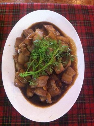 a white plate of food on a table at จอมเมือง Motel in Nan