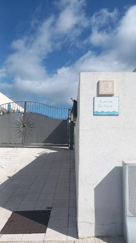 a building with a sign on the side of it at Central Apartment Macari Cala Azzurra Residence in Macari