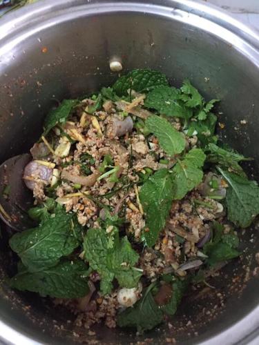 a pot filled with a salad with greens in it at จอมเมือง Motel in Nan
