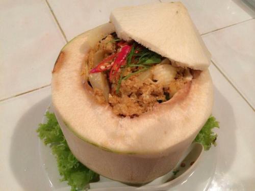 a sandwich on a white plate on a table at จอมเมือง Motel in Nan