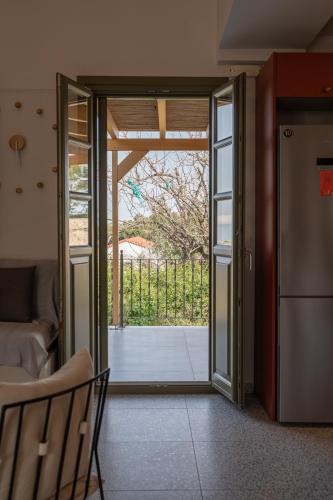 a living room with a door open to a patio at Villa Rosa - Luxury Villas with Panoramic Views in Lagoúdi Zía