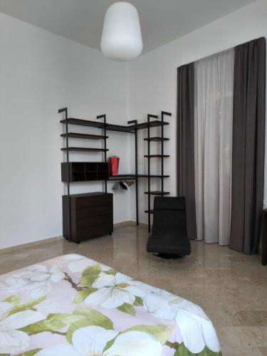 a bedroom with a bed and a book shelf at La Casa Rossa in Brindisi