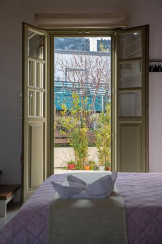 a bedroom with a bed and a large window at Villa Rosa - Luxury Villas with Panoramic Views in Lagoúdi Zía
