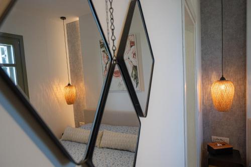 a mirror reflection of a bedroom with a bed at Villa Rosa - Luxury Villas with Panoramic Views in Lagoúdi Zía