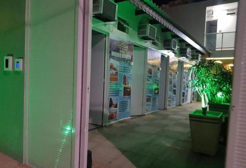 a hallway in a building with a potted plant at Pousada Do Futuro in Fortaleza