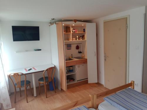 a small room with a table and two chairs at Sobe Černilogar in Tolmin