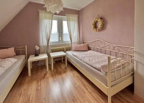 a bedroom with two beds and a window at Ferienwohnung Paulita in Soltau