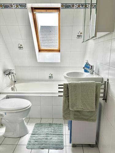 a white bathroom with a sink and a toilet at Ferienwohnung Paulita in Soltau